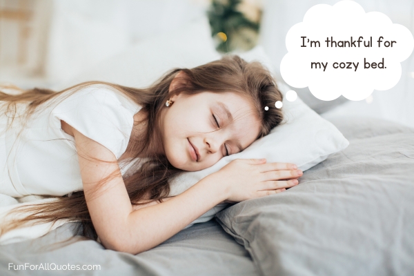 Little girl asleep on her bed, with gratitude quote on thought bubble
